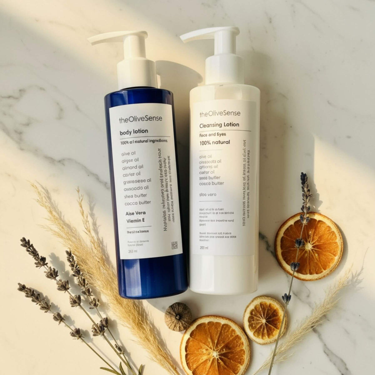 Two bottles of 'theOliveSense' skincare products on a marble surface with dried oranges and lavender.