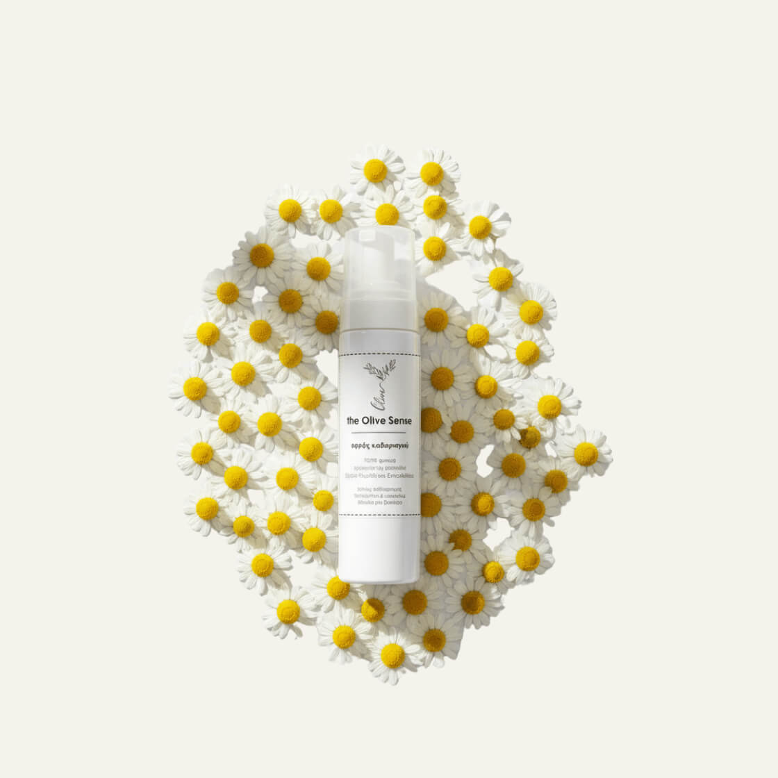 White bottle with Skincare of theOliveSense Cleaning Foam with Chamomile & vitamin E soap  on a decorative white and yellow flower pattern 