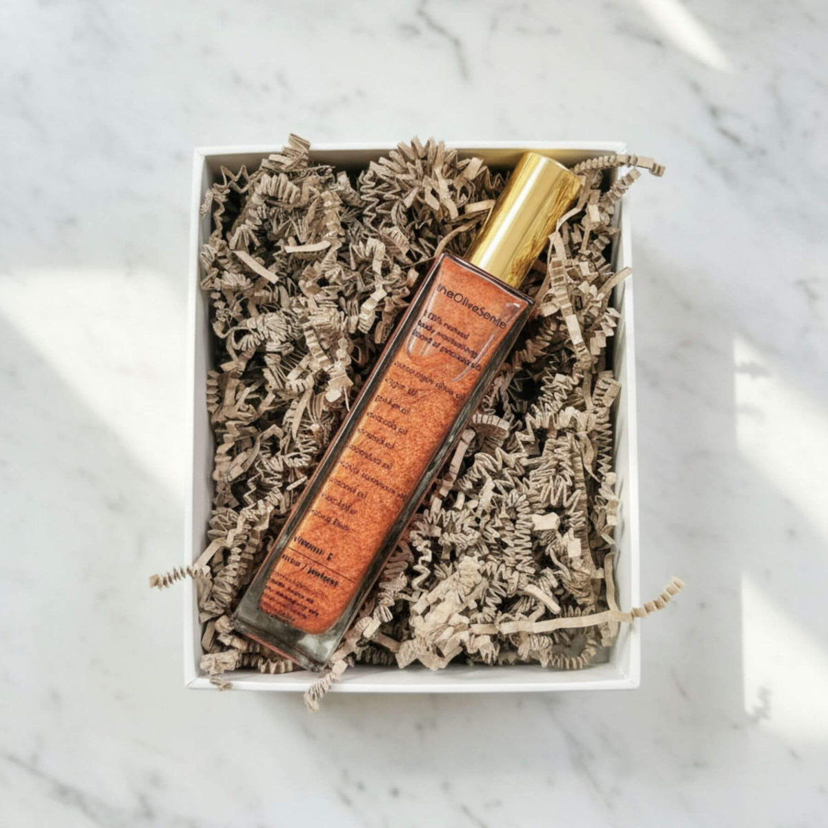 Lip balm in a decorative box on a marble surface