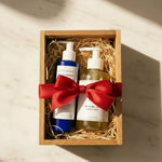 Two skincare products in a wooden box with a red ribbon on a light background