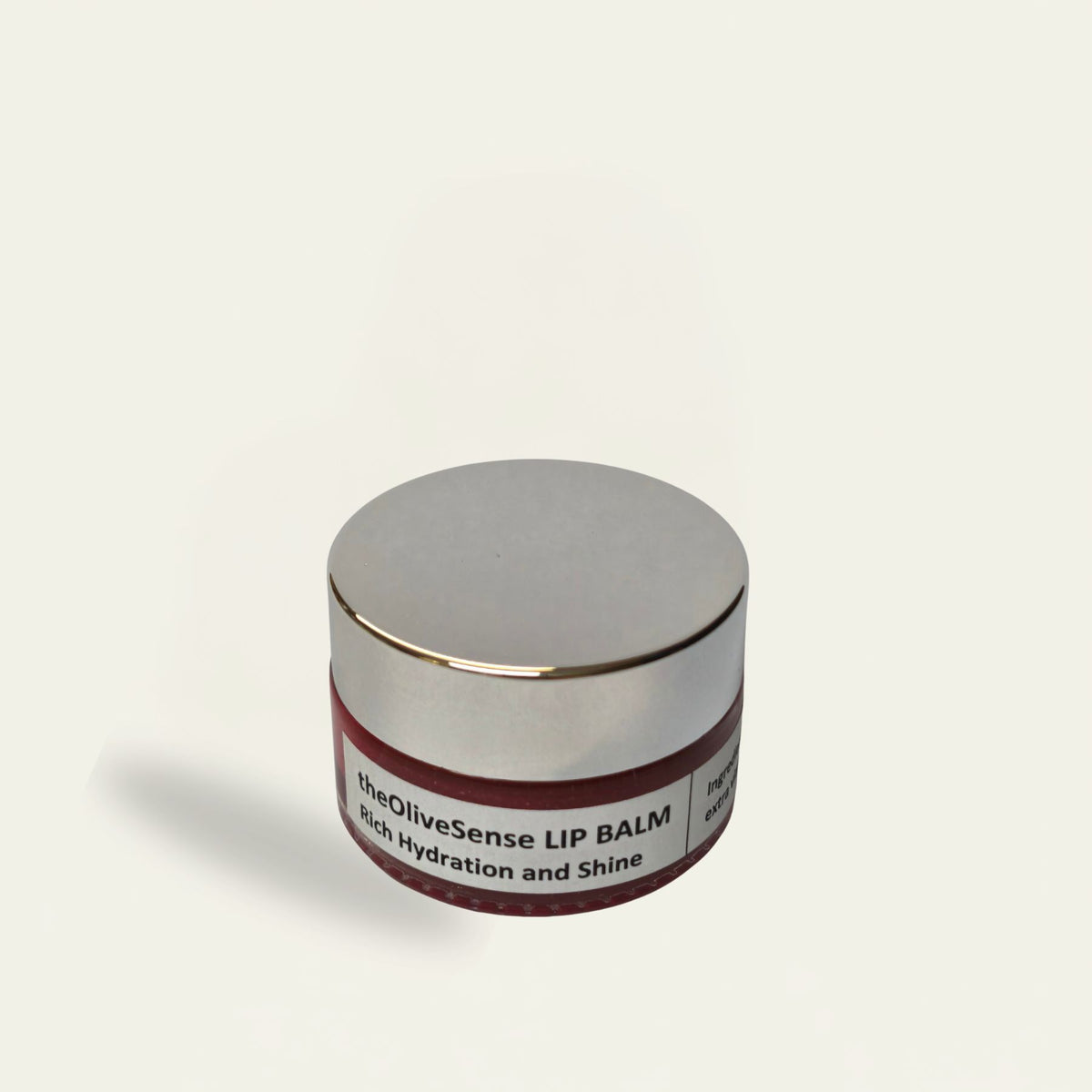 Lip balm container with a label on a white background
