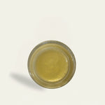 Small round container with a metallic rim on a light gray background