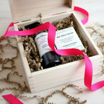 Gift set with 'The Olive Sense' products in a wooden box with pink ribbon