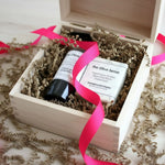 Two bottles of 'the Olive Sense' product in a wooden gift box with a pink ribbon.