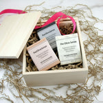 Gift set with 'the Olive Sense' products in a wooden box on a white background.