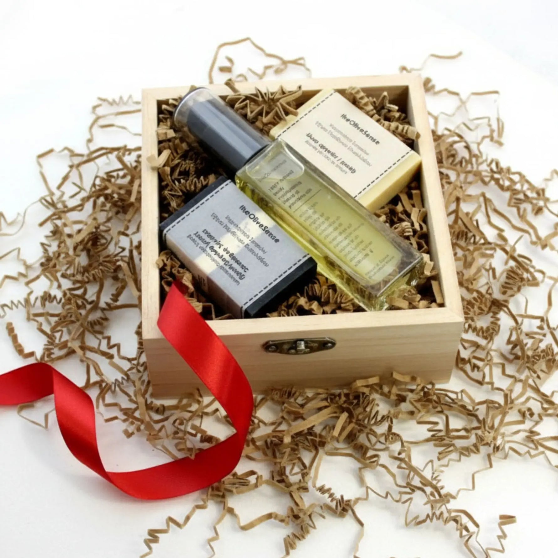 Two skincare products in a wooden box with a red ribbon on a white background