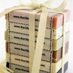 Stack of soap bars with a ribbon, branded 'The Olive Tree'.