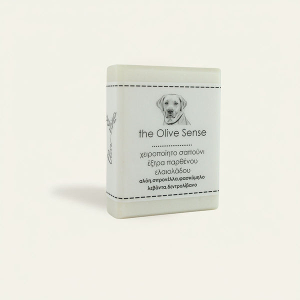 A white bar of pet soap with a label featuring a dog and the text 'The OliveSense Pet Soap Bar, extra virgin olive oil, 100% all natural ingredients, deep cleanses, hydrates, offers natural anti-parasitic 